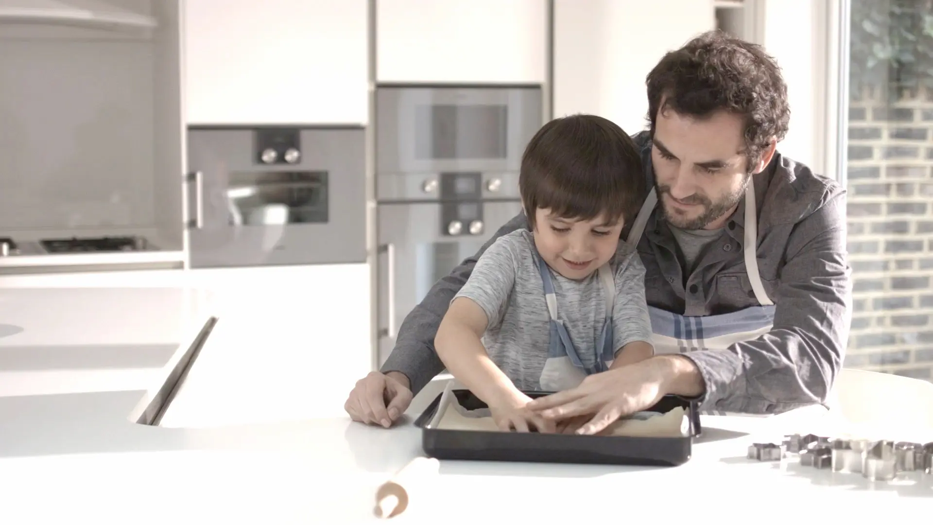 Father and son baking together.