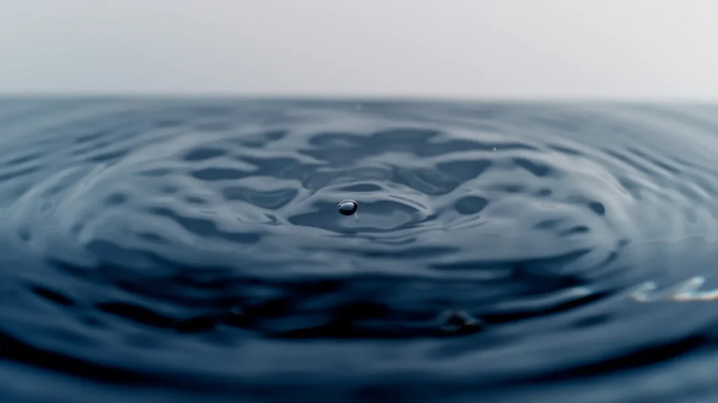 Droplet creating ripples on water