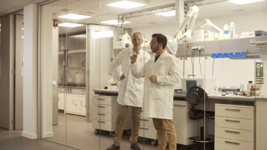 Two scientists in a laboratory setting.
