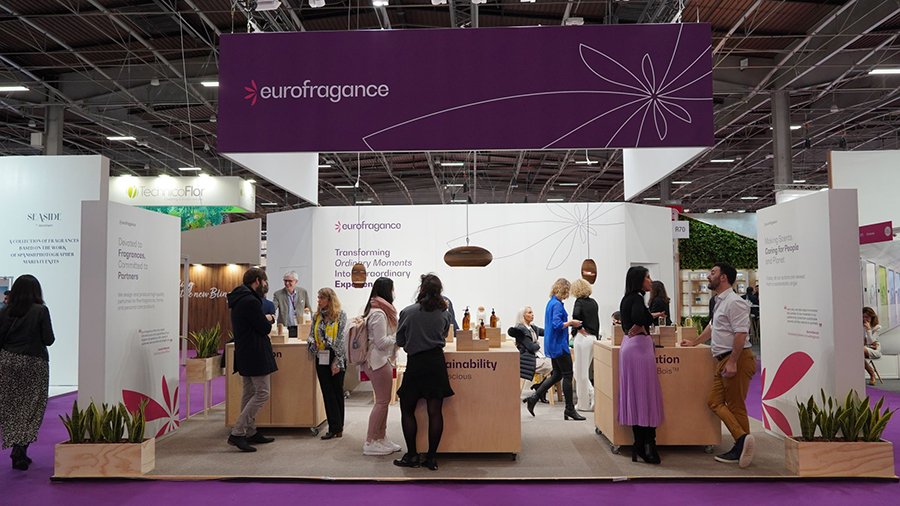 Eurofragance sustainable cosmetics and fragrances exhibition booth with visitors.