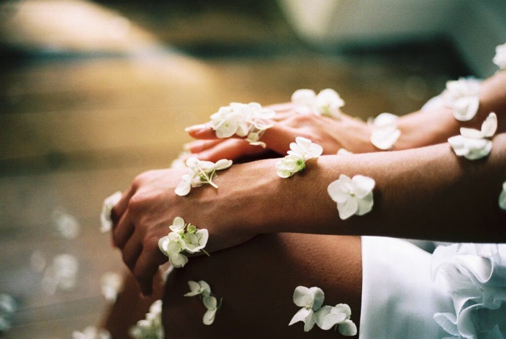 Hands adorned with delicate white flowers