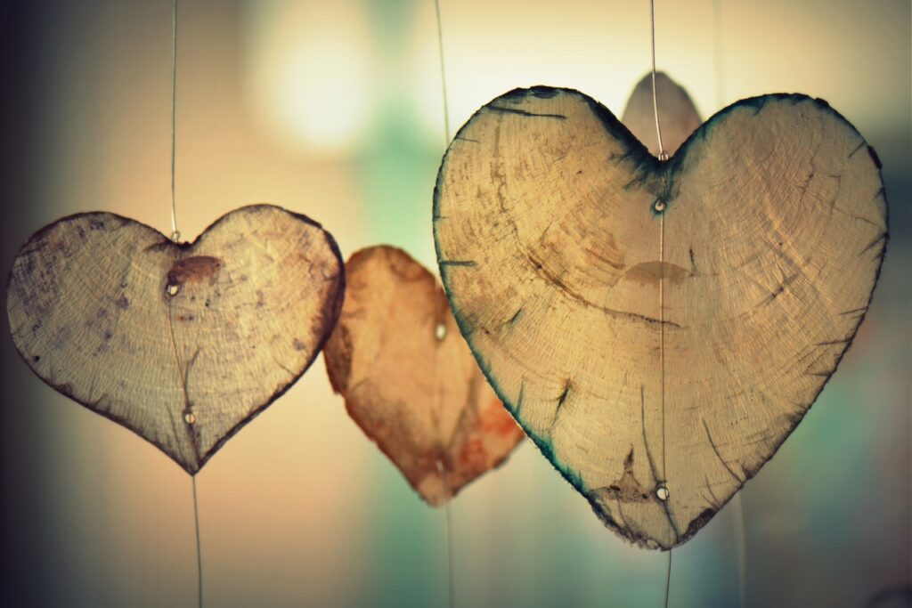Hanging wooden hearts in soft light.