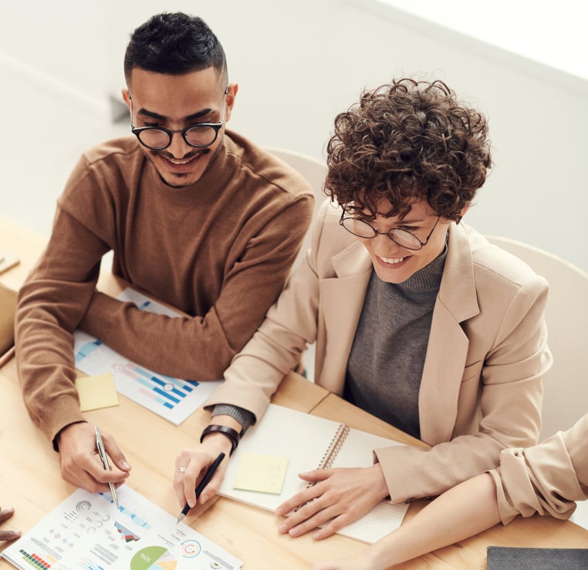 People collaborating over business documents.