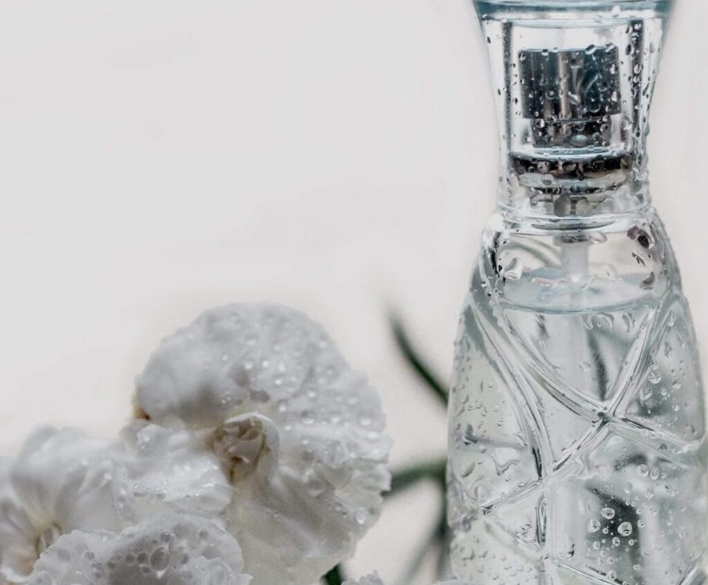 Elegant perfume bottle with flowers.