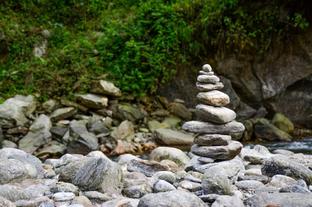 Stacked stones by a riverbank.