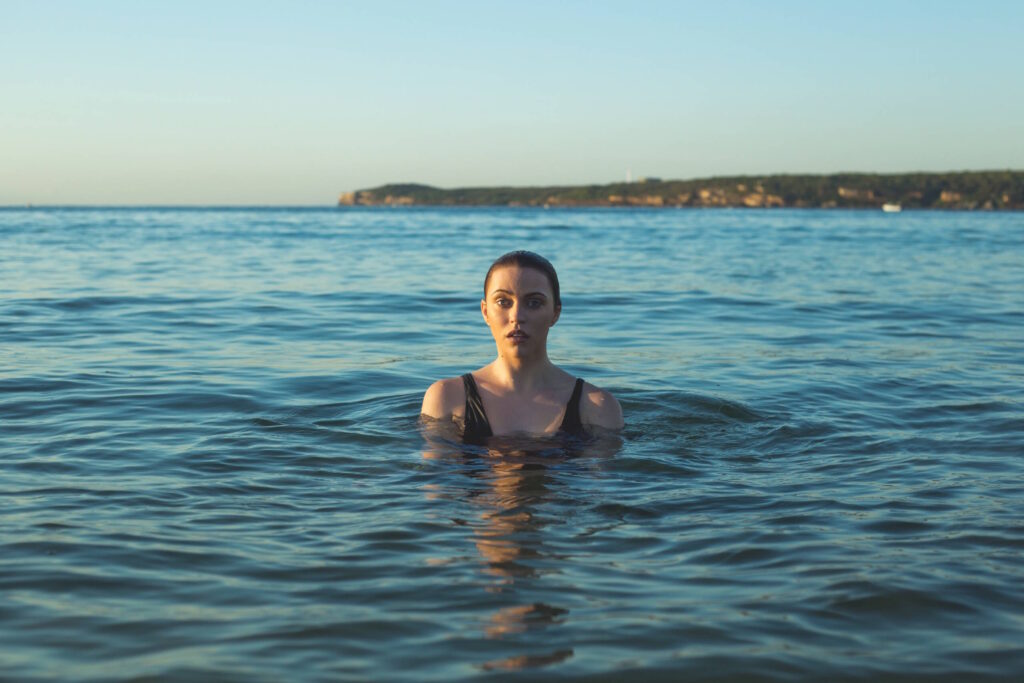 Person standing in calm water.