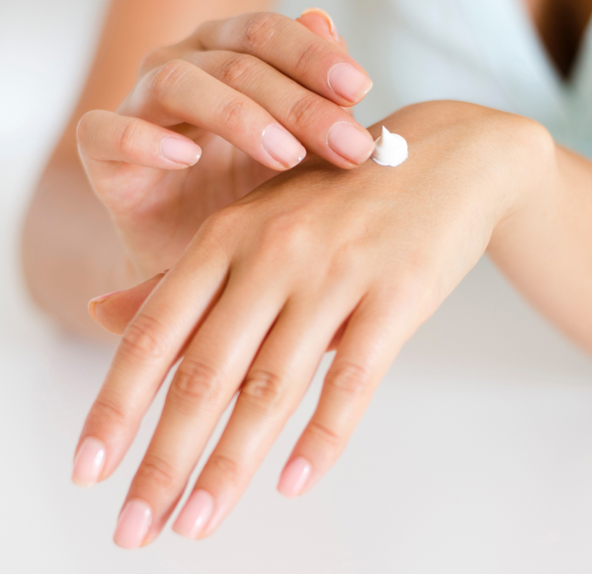 Applying cream to a hand.