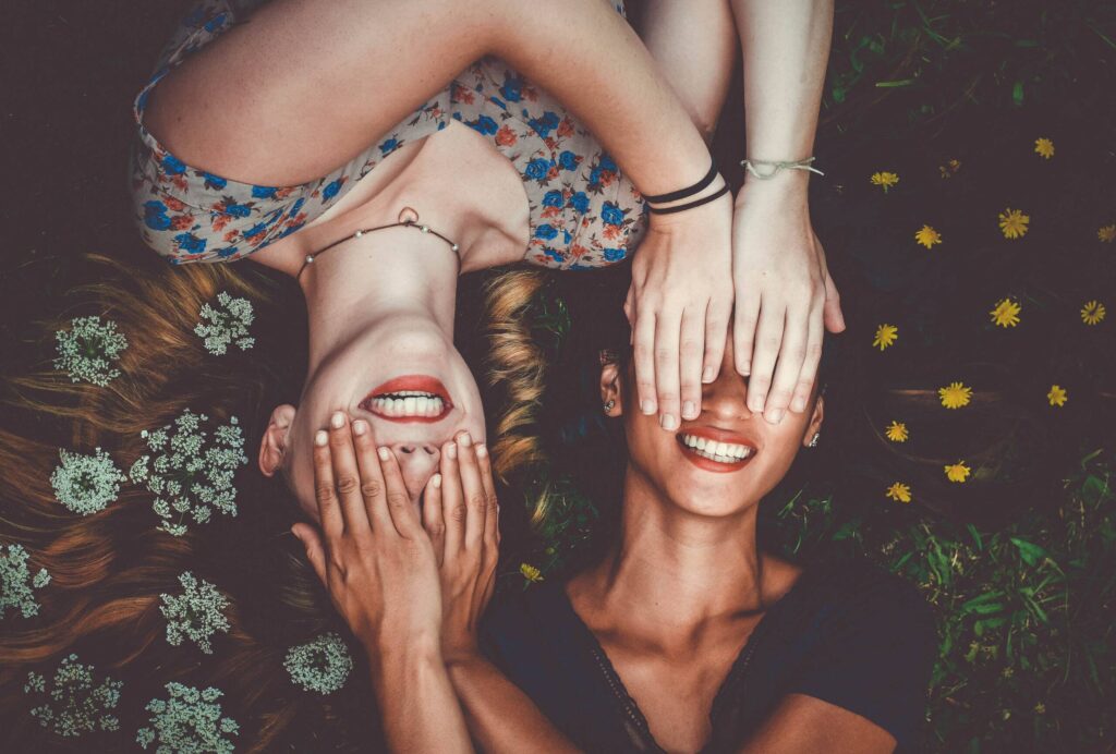 Two friends lying in flowers.