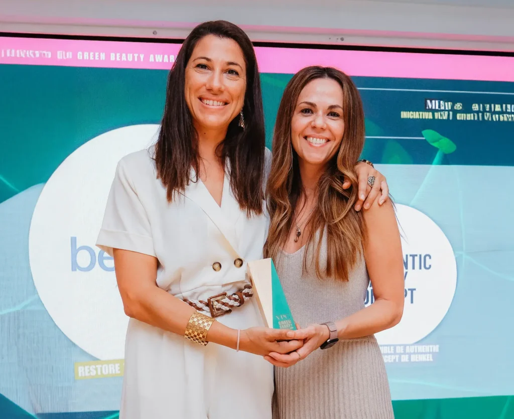 Two women holding an award for Eurofragance.