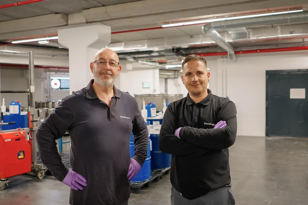 Two workers in an Eurofragance warehouse setting.